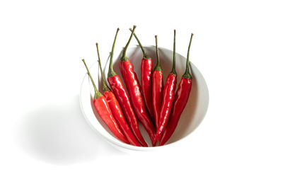 Close-up of red chili pepper over white background