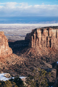 View of rock formations against cloudy sky