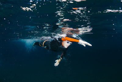 Underwater view of man diving in sea