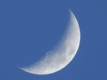 Majestic view of moon against blue sky