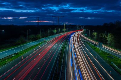 High angle view of light trails on highway at night