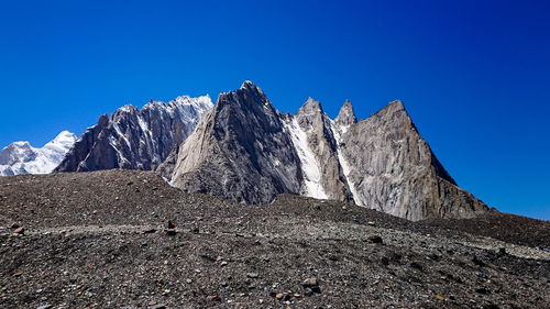 Scenic view of rocky mountains against clear blue sky
