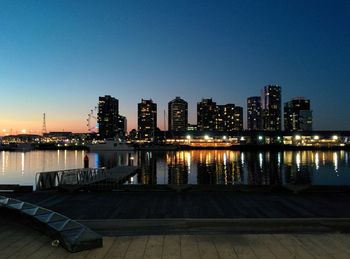 Illuminated buildings with waterfront at night