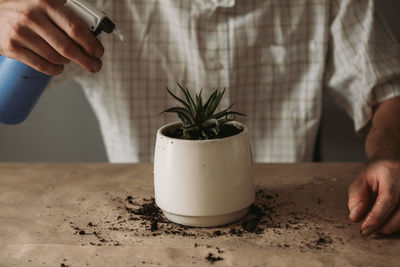 Close-up of man holding ice cream on table