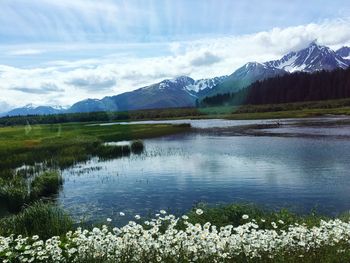 Scenic view of lake and mountains against sky