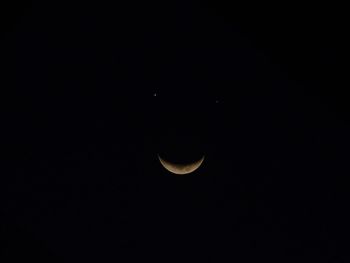 Low angle view of moon against sky at night