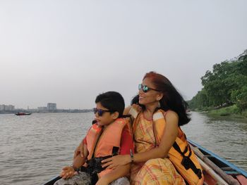 Friends on boat against sky