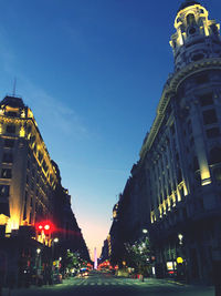 Low angle view of illuminated city buildings against sky