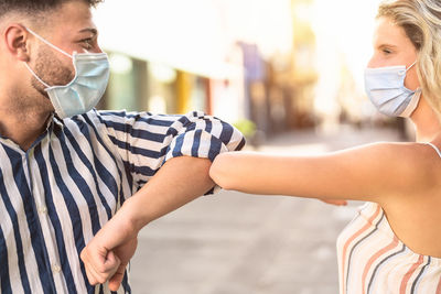 Midsection of couple standing outdoors