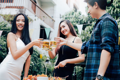 Portrait of a smiling young woman with drink