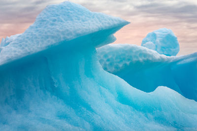 Close-up of ice crystals against sky