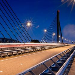 Suspension bridge against blue sky