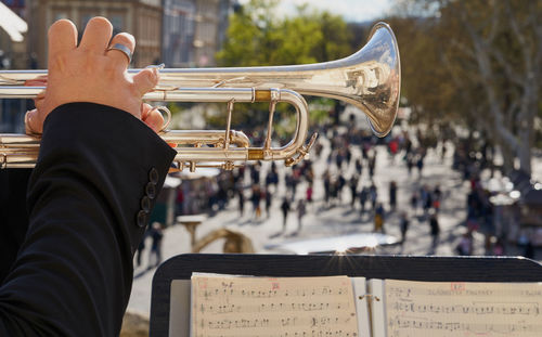 Cropped hand of man playing trumpet