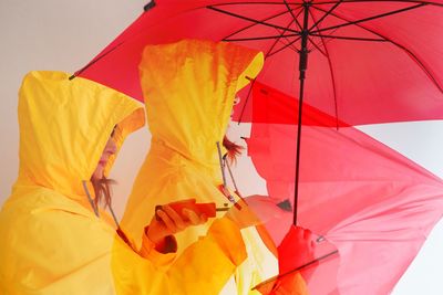 Low angle view of man holding umbrella