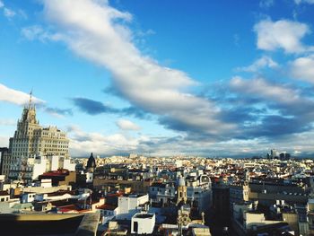 Cityscape against cloudy sky