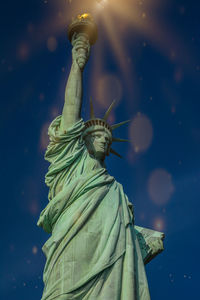 Low angle view of statue of liberty against sky