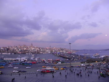 High angle view of people in city against sky during sunset