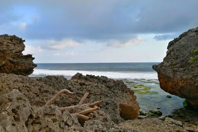 Rocks on beach against sky