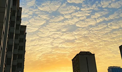 Low angle view of building against cloudy sky