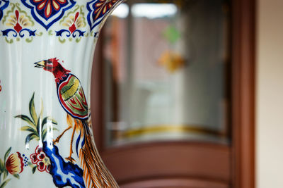 Close-up of colorful curtain by window