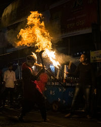 Group of people in front of fire at night