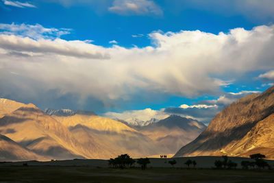 Scenic view of lake by mountains against sky