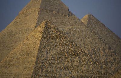 Pyramids of giza against clear blue sky