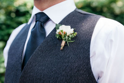 Close-up of well-dressed man wearing corsage