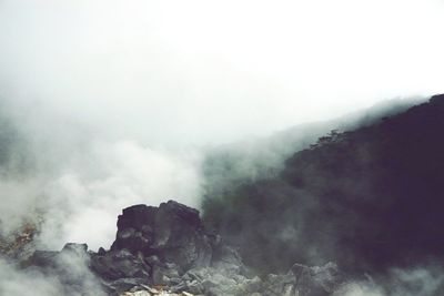 Scenic view of mountains against cloudy sky