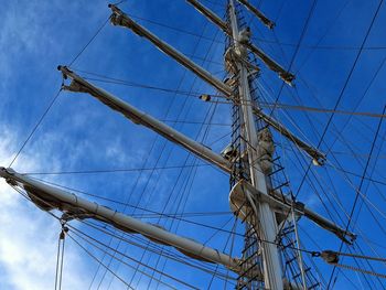 Low angle view of mast against blue sky