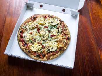 High angle view of pizza in plate on table