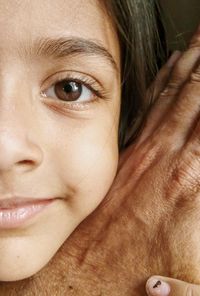 Cropped girl holding hand of grandparent