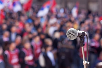 Close-up of microphone against crowd