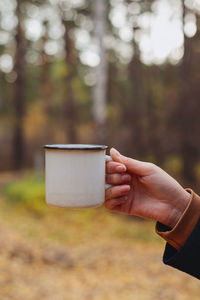 Human hand holding coffee cup