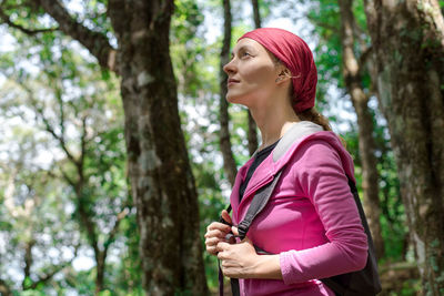 Woman looking away in forest