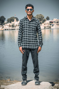Portrait of young man wearing sunglasses standing outdoors
