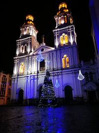 Low angle view of illuminated building at night