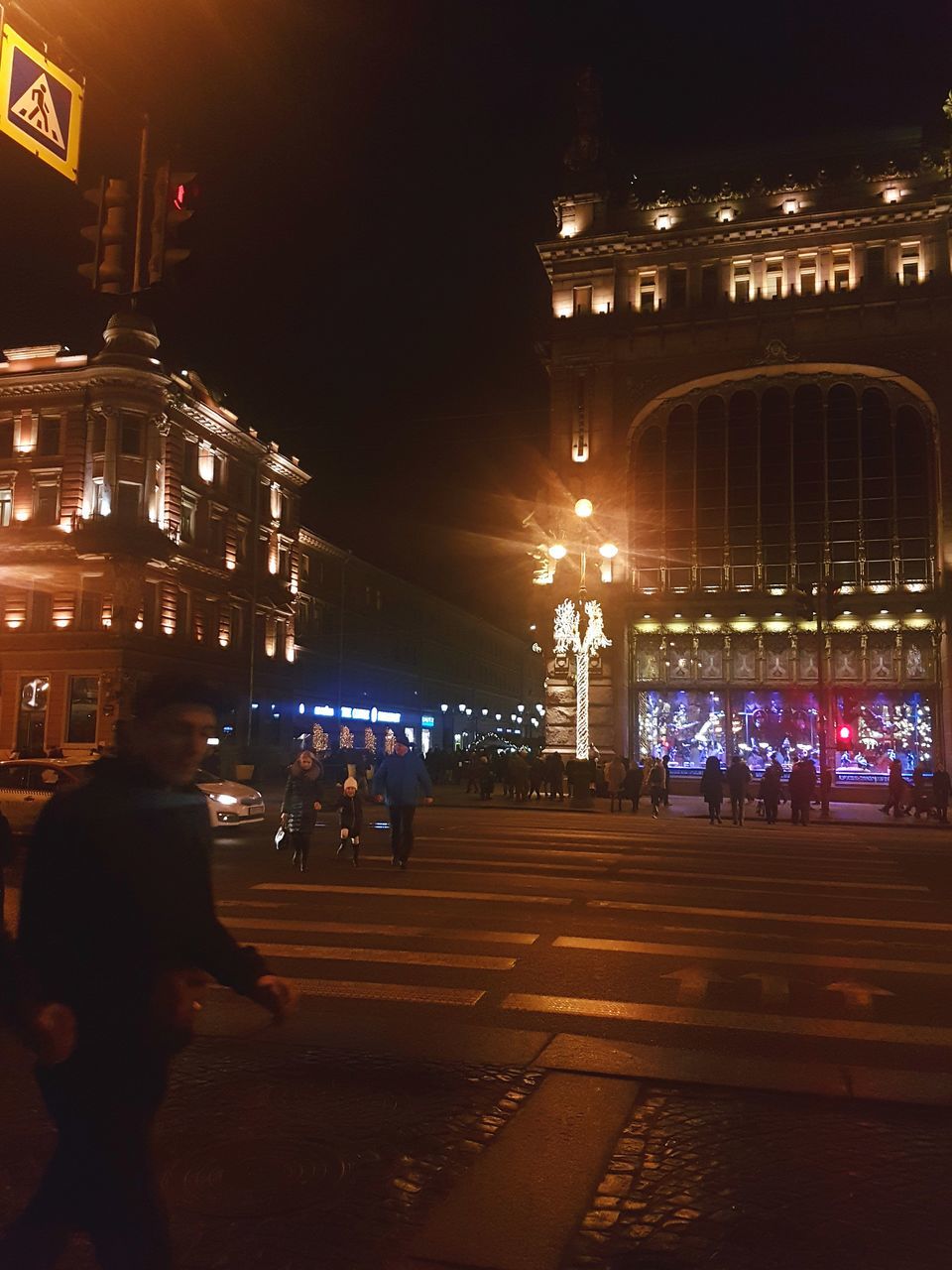 PEOPLE ON ILLUMINATED CITY AT NIGHT