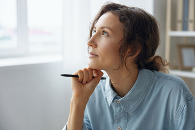 Side view of young woman using mobile phone