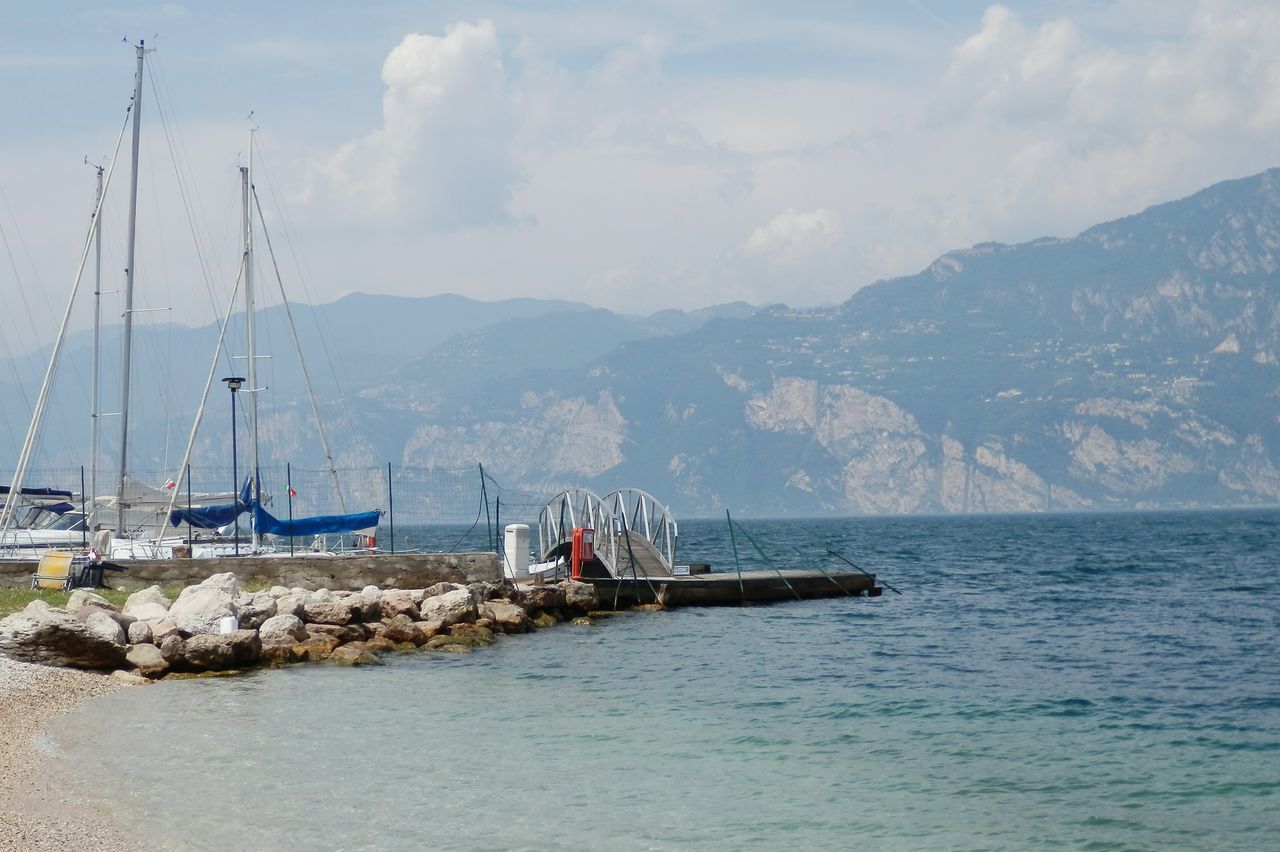 nautical vessel, mode of transport, transportation, water, boat, sea, mountain, nature, waterfront, sky, moored, no people, scenics, day, cloud - sky, outdoors, sailboat, tranquility, mast, beauty in nature, sailing, harbor