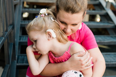 Side view of mother and daughter