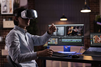 Portrait of young man using mobile phone in office
