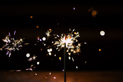 Low angle view of firework display at night