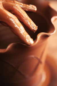 Crop potter making pot in workshop