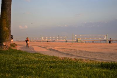 Women riding bicycles at beach