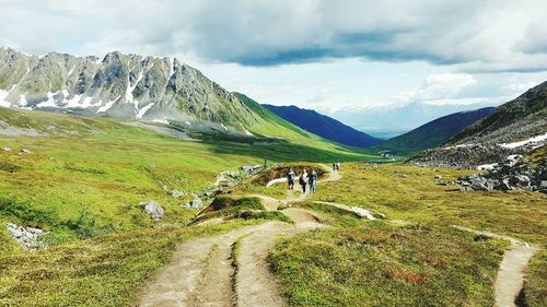 People walking on countryside landscape