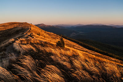 Scenic view of mountains against clear sky during sunset