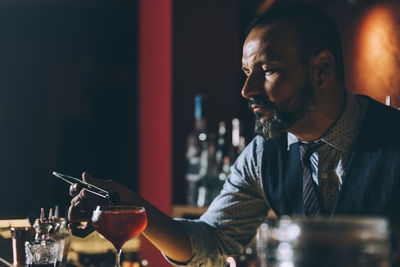 Midsection of a man drinking glass