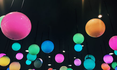 Low angle view of colorful balloons against clear sky