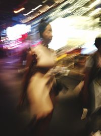 Blurred motion of people walking on road